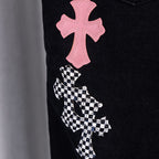 Black denim pants with pink cross patch above checkered cross patch.