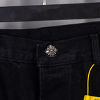 Black denim pants with metal button and belt-loop detail at waistband