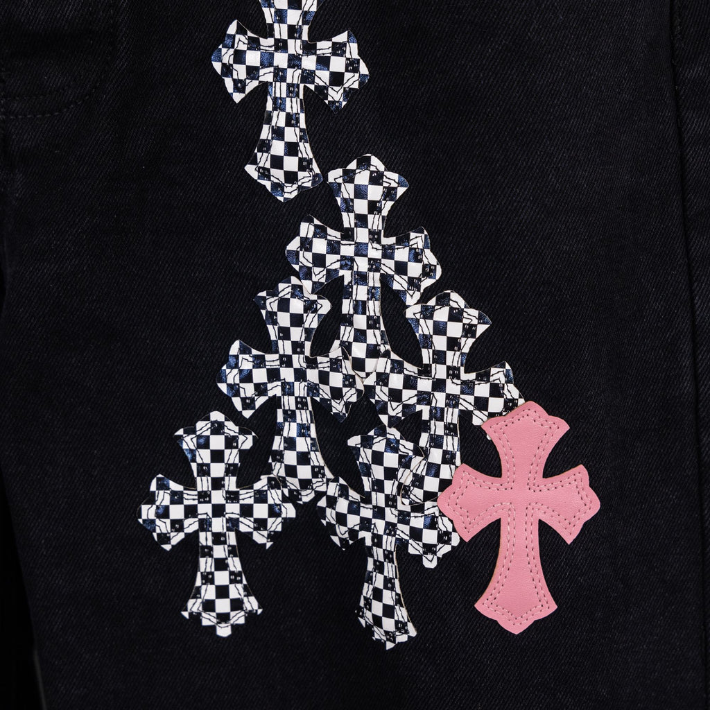 Black denim pants with large checkerboard cross graphic and pink cross emblem