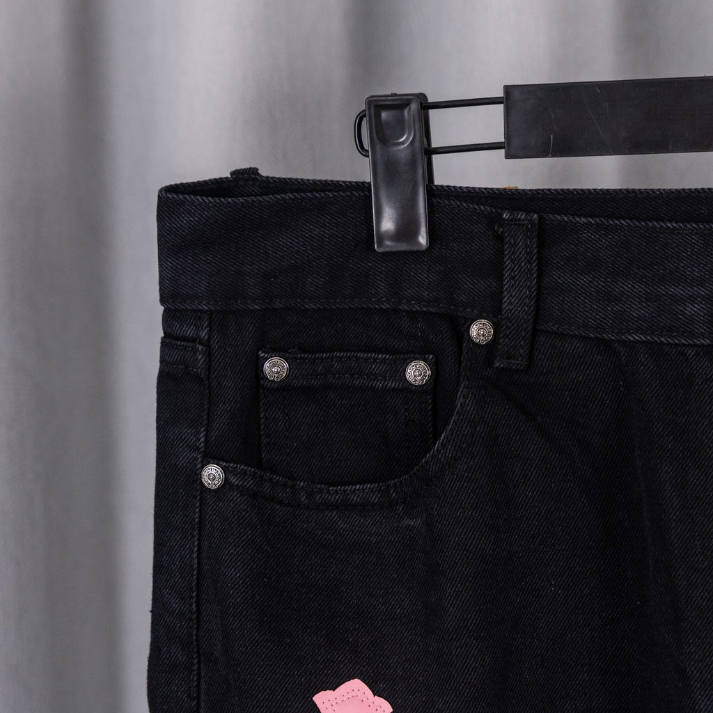 Dark denim jean pocket and waistband with metal rivets and belt loop detail.