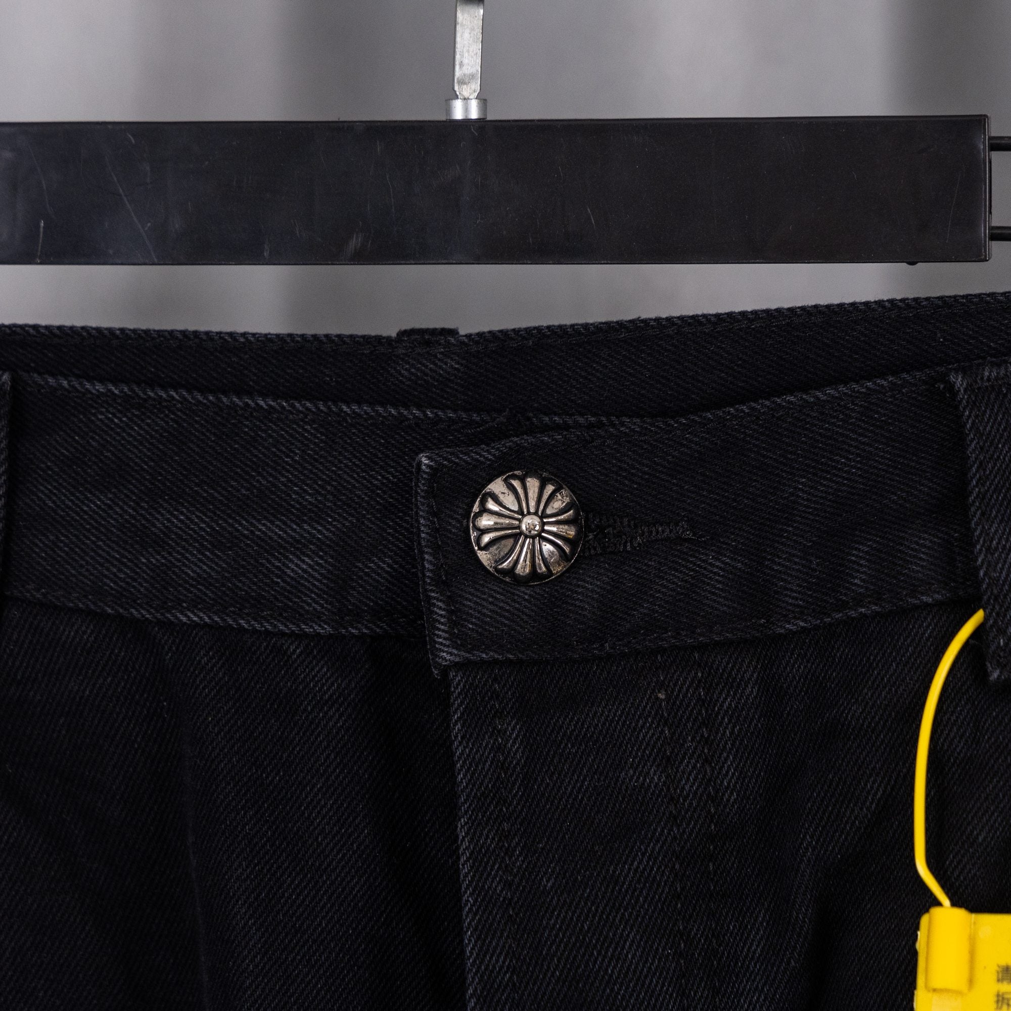Black pants with silver button and front pocket stitching
