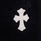 Black denim pants with white cross applique patch on pocket