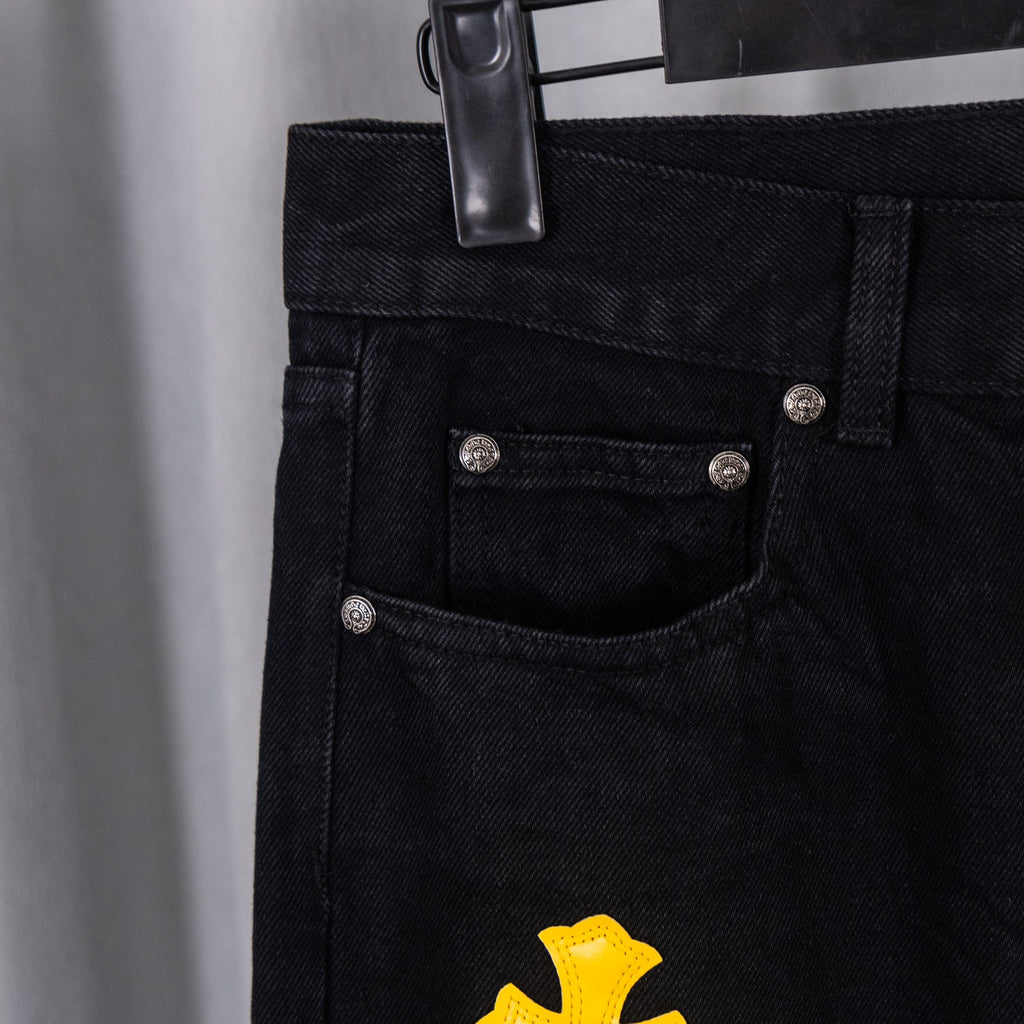 Black denim jeans waistband with coin snap button and front pocket detail