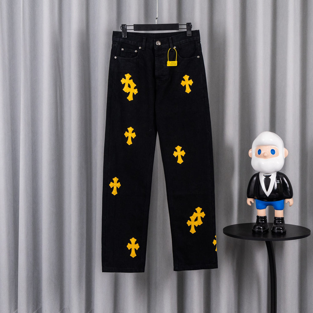 Black denim pants with yellow cross patches, button fly and belt loops