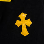 Yellow cross applique patch on black denim fabric
