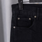 Black denim pants with front pocket and buttoned waistband detail