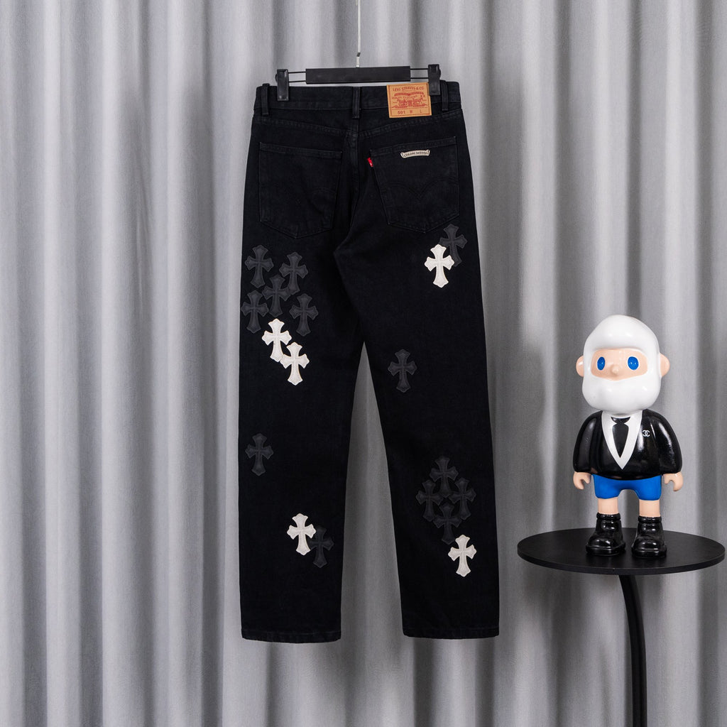 Black pants with dark cross patches, back view on hanger