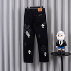 Black pants with dark cross patches, back view on hanger