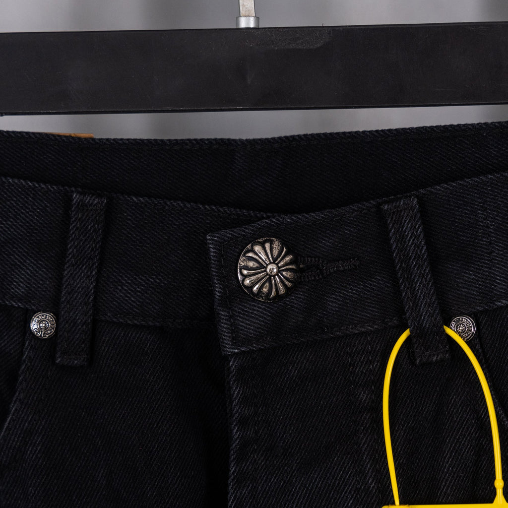 Black denim pants with coin pocket, decorative center button, and belt loops