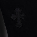 Black denim pants with embroidered cross emblem patch