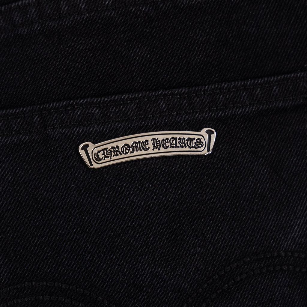 Black denim pants with stitched logo tab near the pocket