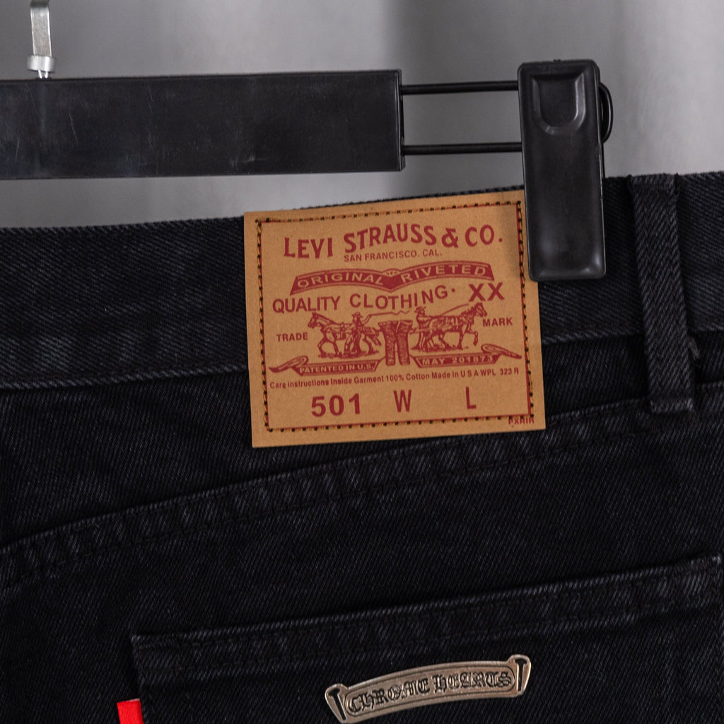 Black denim pants with Levi Strauss & Co label and small rectangular tag