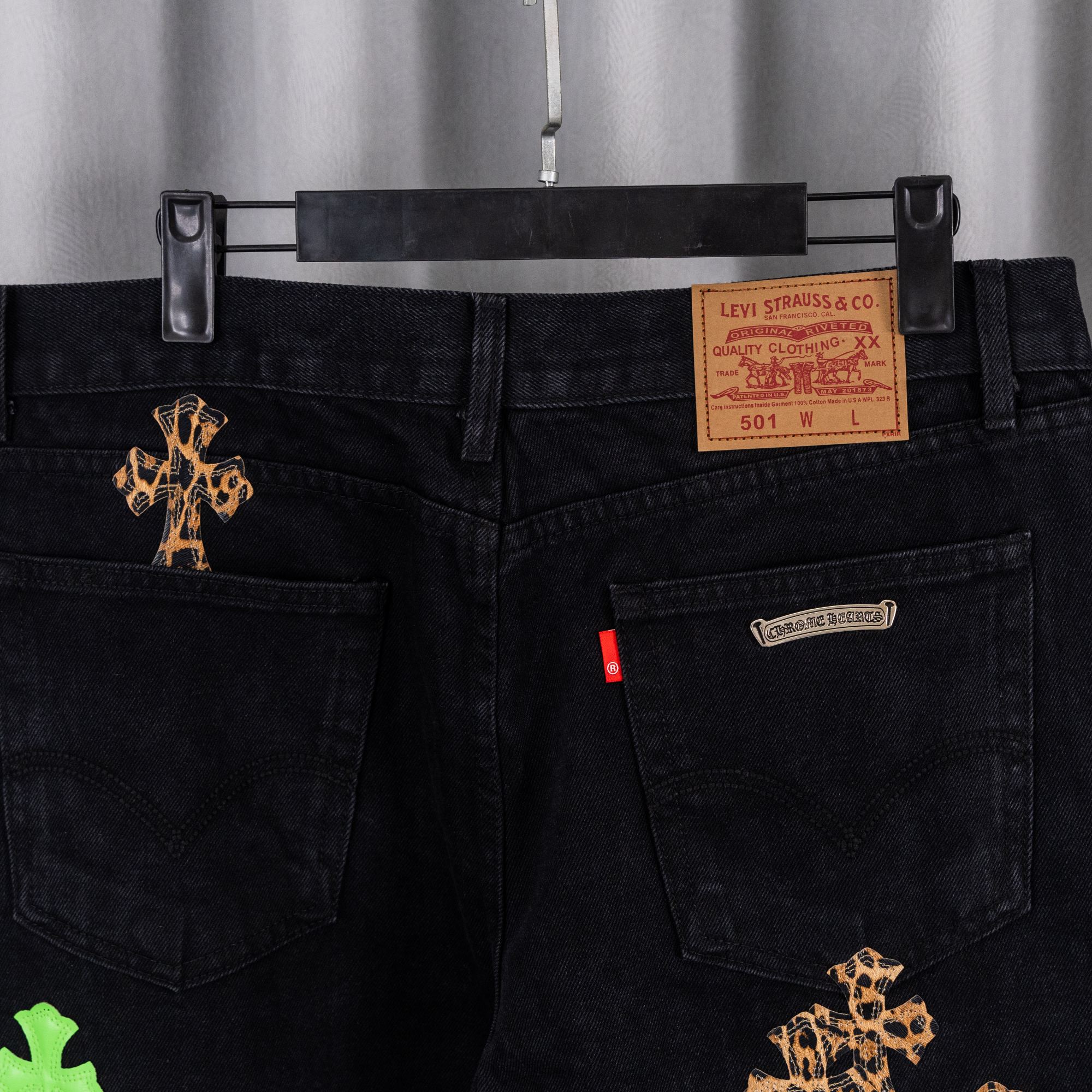 Black denim pants front with Levi Strauss & Co label and cross embroidery