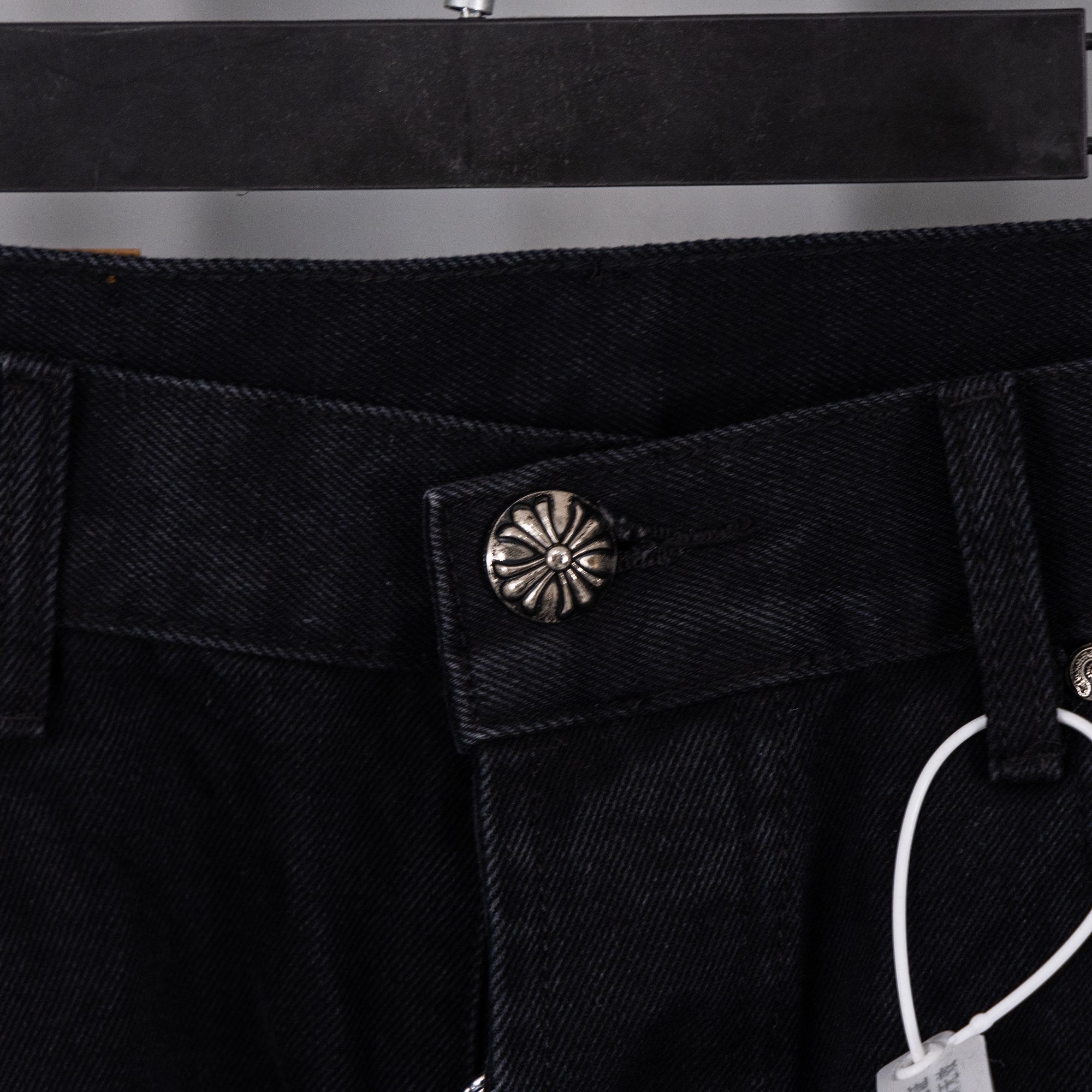Black denim Chrome pants with embossed button and inner pocket detail