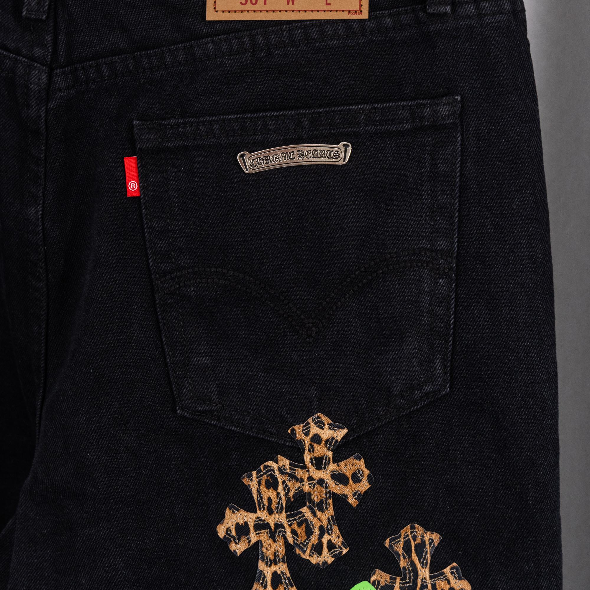 Black denim Chrome pants with leopard graphic on front pocket