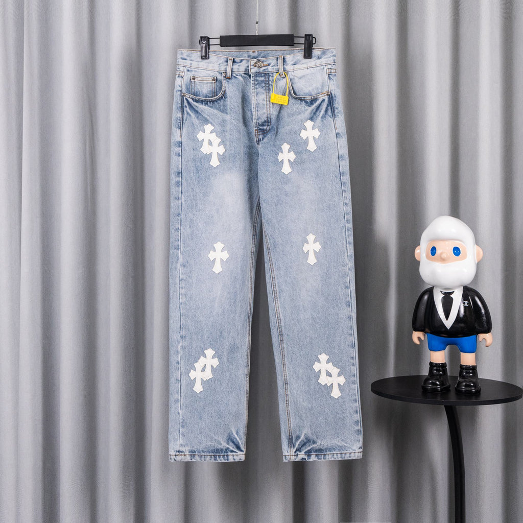 Light blue denim jeans with white cross patches, button fly and belt loops.
