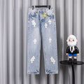 Light blue denim jeans with white cross patches, button fly and belt loops.