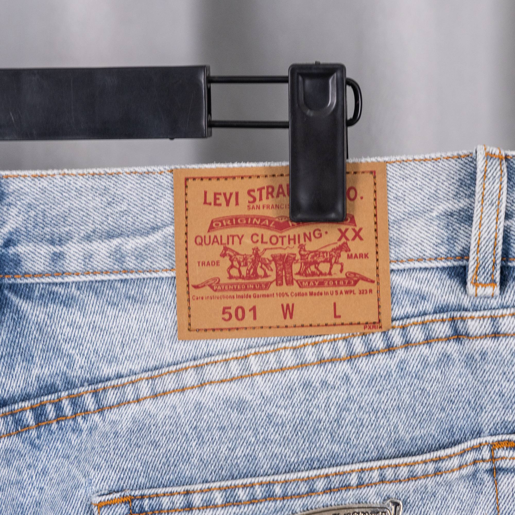 Levi Strauss denim waistband tag with belt loops and white cross patches.