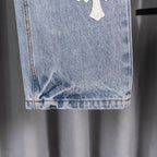 Chrome pants hem and cuffs detail on light blue denim with visible stitching