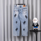 Light blue denim jeans back view with black cross patches and straight legs