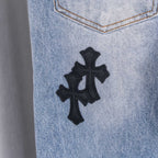 Light blue denim pants with centered black cross patch