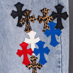 Light blue denim jeans with multicolor cross applique design