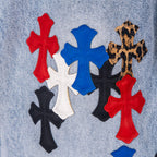 Light blue denim jeans with red, blue, white, and black cross appliques