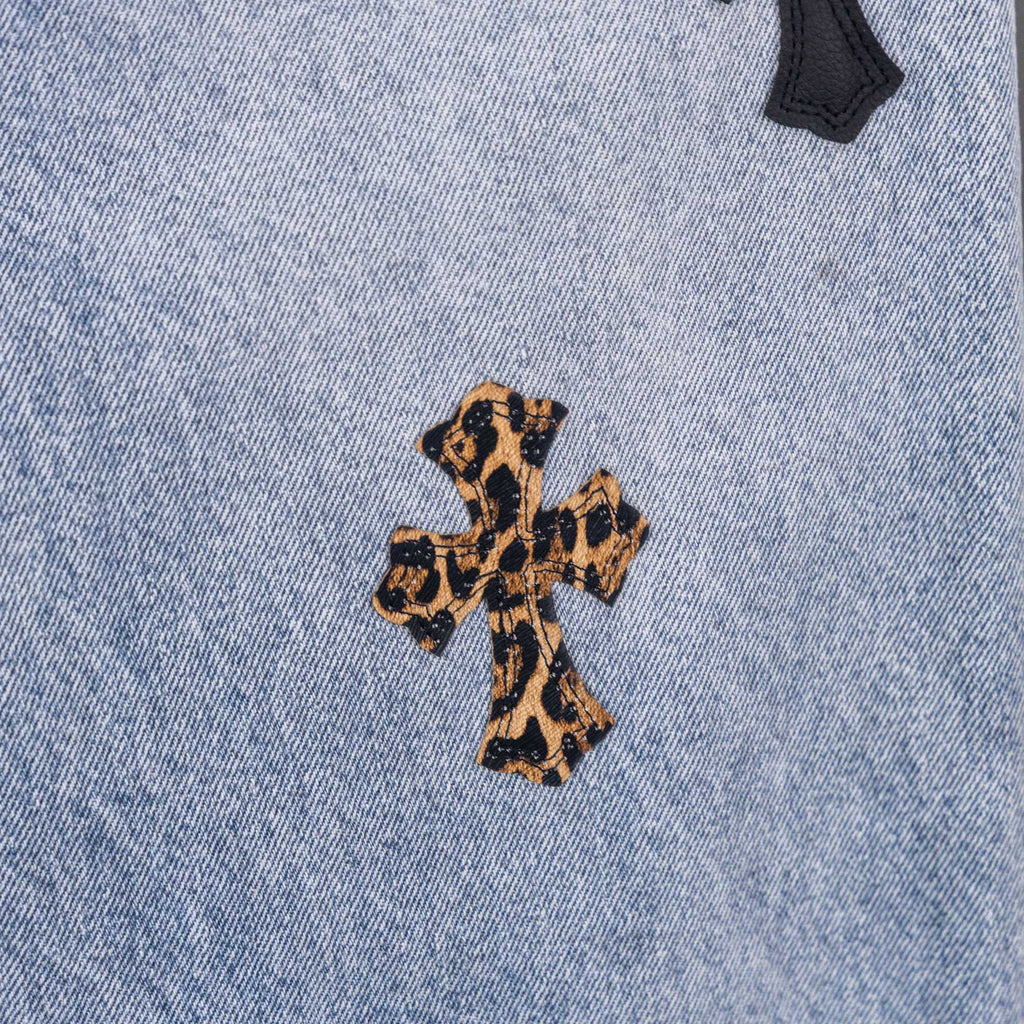 Light blue denim jeans with leopard print cross applique