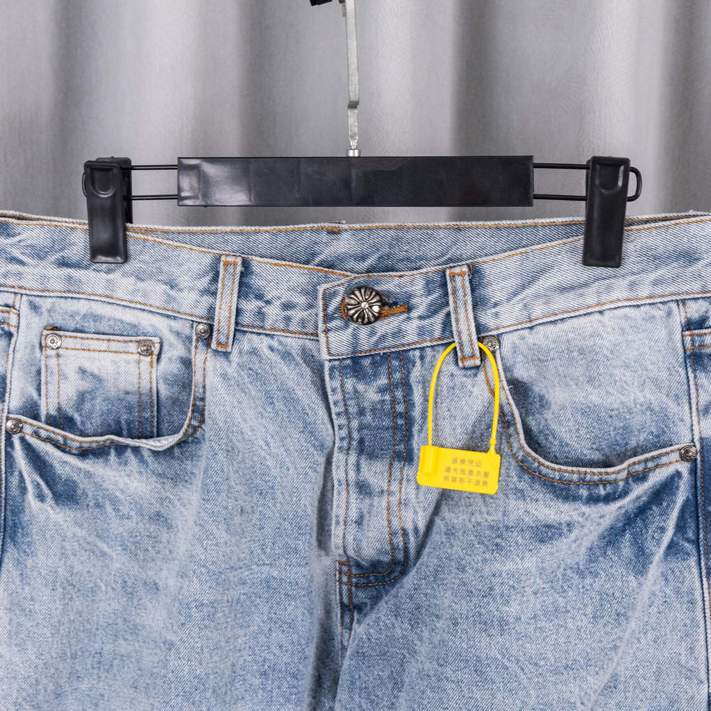 Light blue denim pants with belt loops, front fly, and yellow tag