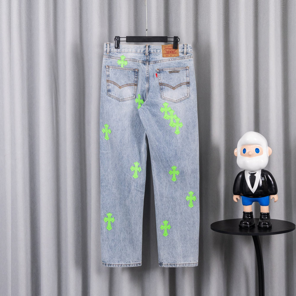Light blue denim pants with neon green cross patches and back pockets detail