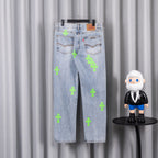 Light blue denim pants with neon green cross patches and back pockets detail