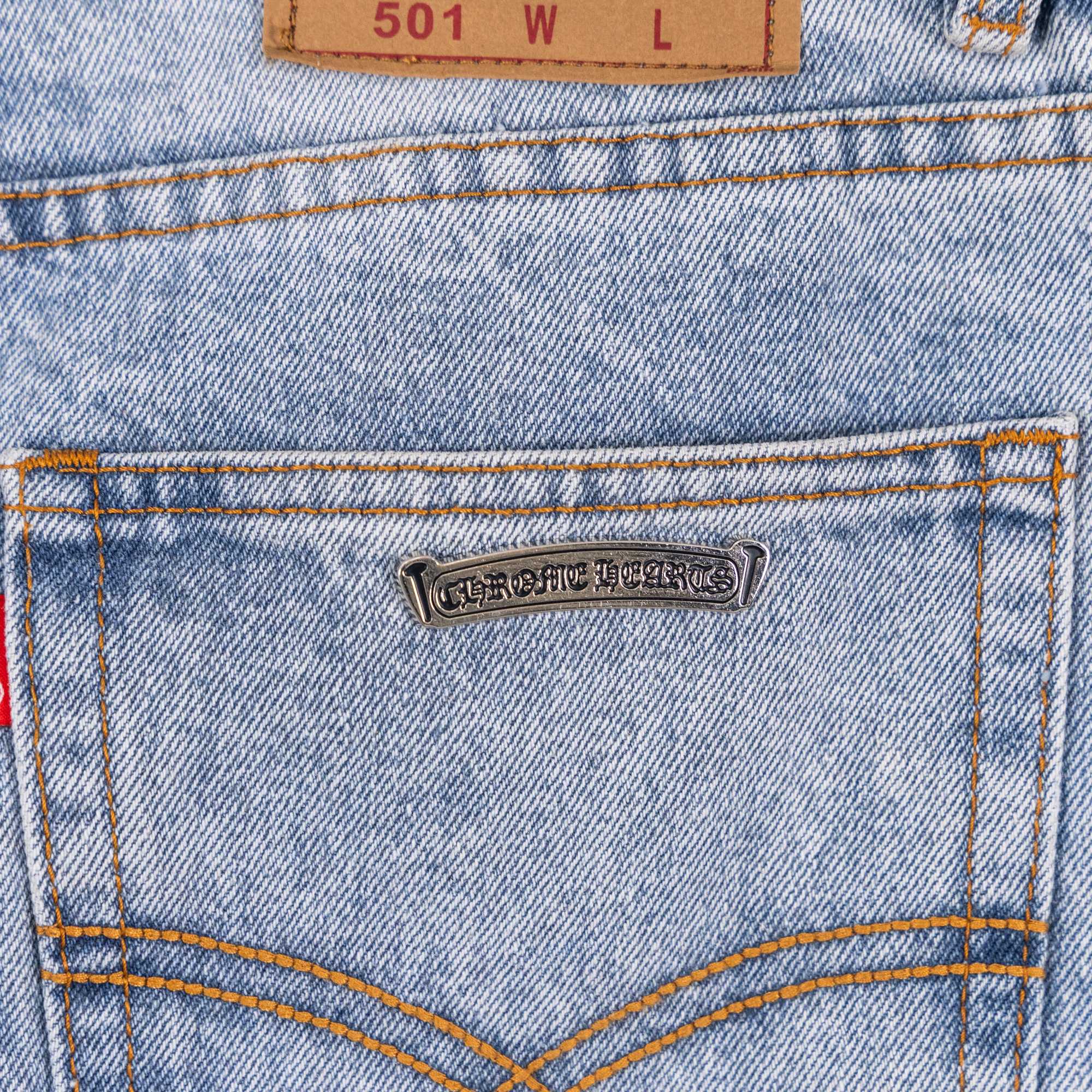 Denim pants with stitched back pocket and metal brand plate