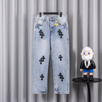 Light wash denim pants with black cross patches on front and back