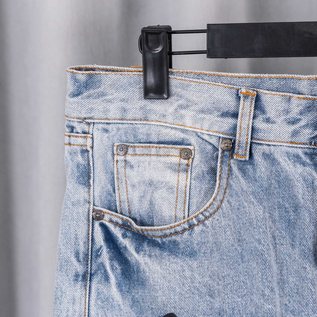 Light wash denim pants back pocket with coin pocket and stitched trim