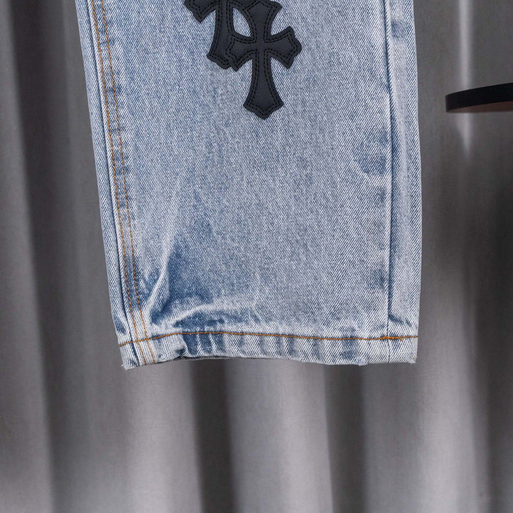Light blue denim pants hem with frayed cuff and straight leg opening