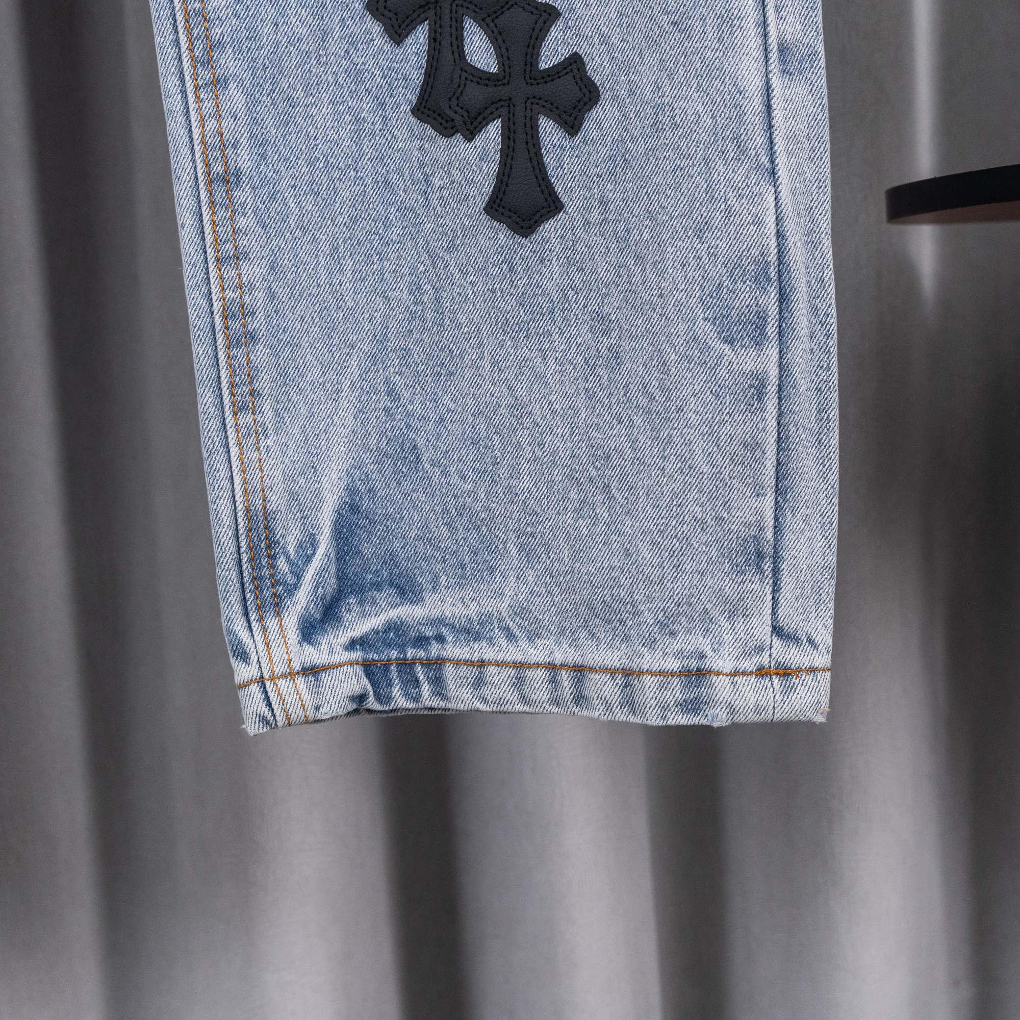Light blue denim pants hem with frayed cuff and straight leg opening