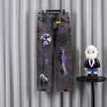 Chrome pants with gray wash, purple and black patches, and a yellow tag at the waist