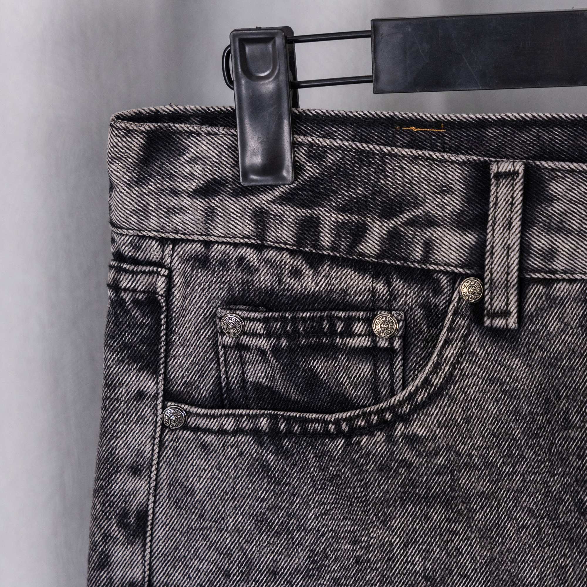 Chrome pants back close-up: gray denim waistband with belt loops and back pocket