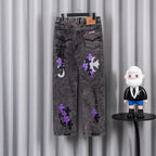 Chrome pants with gray wash and scattered purple and black patches on the front