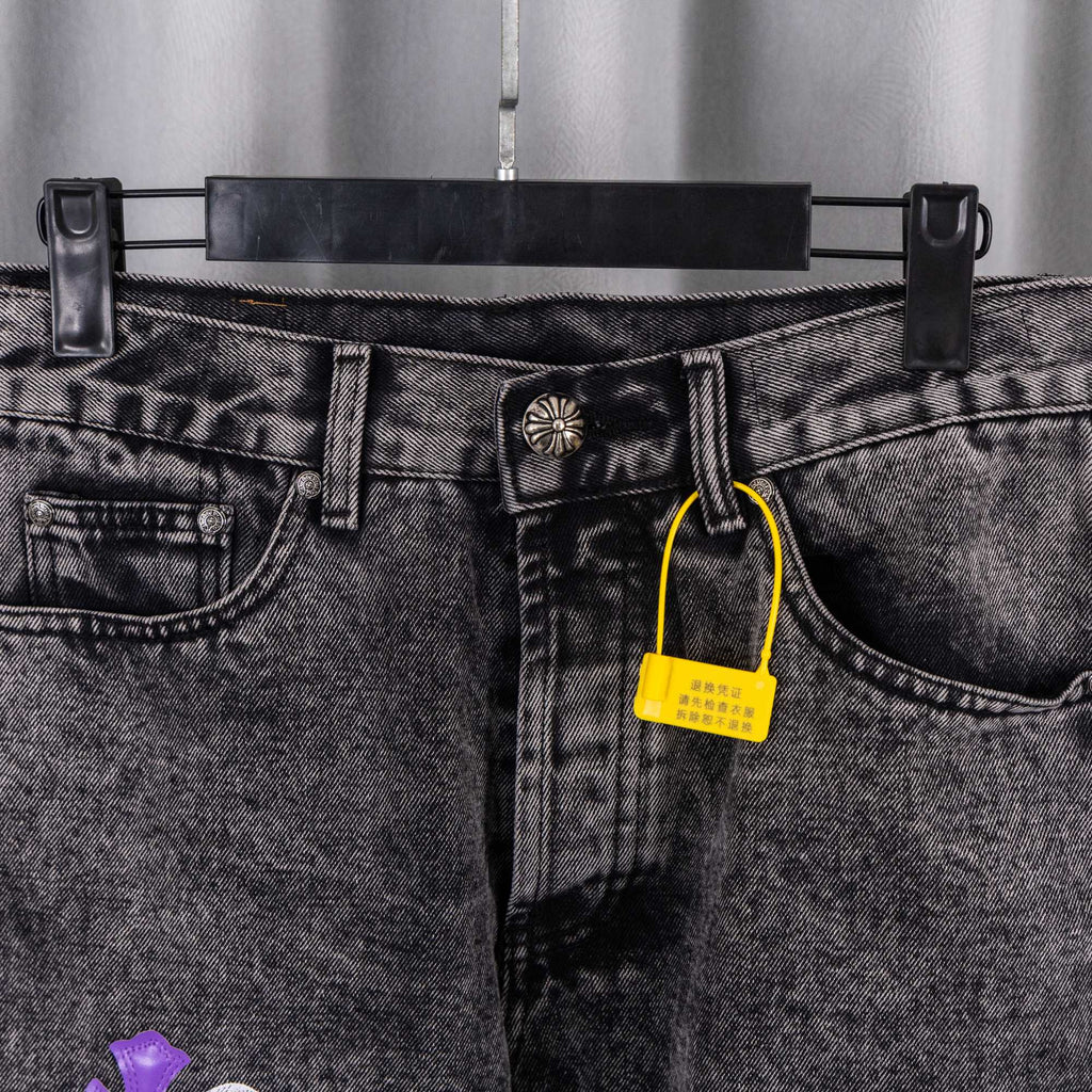 Chrome pants front close-up: gray denim with belt loops and a yellow hanging tag