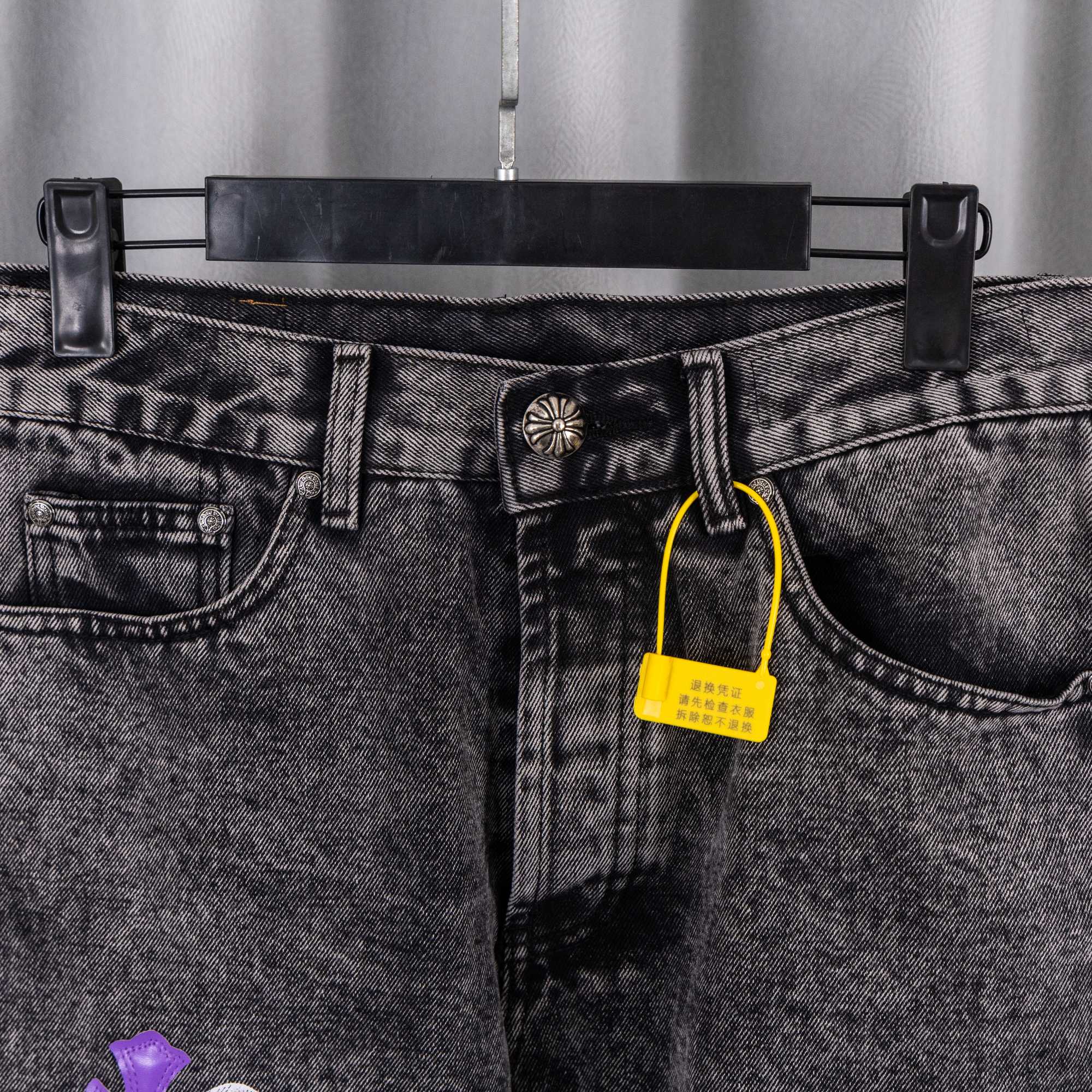 Chrome pants front close-up: gray denim with belt loops and a yellow hanging tag