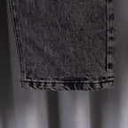 Chrome pants hem close-up on gray denim with visible stitching and folded cuff