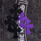 Chrome pants patch close-up with purple cross graphic and black crossed icons