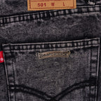 Chrome pants back pocket close-up with metal logo patch and size label above