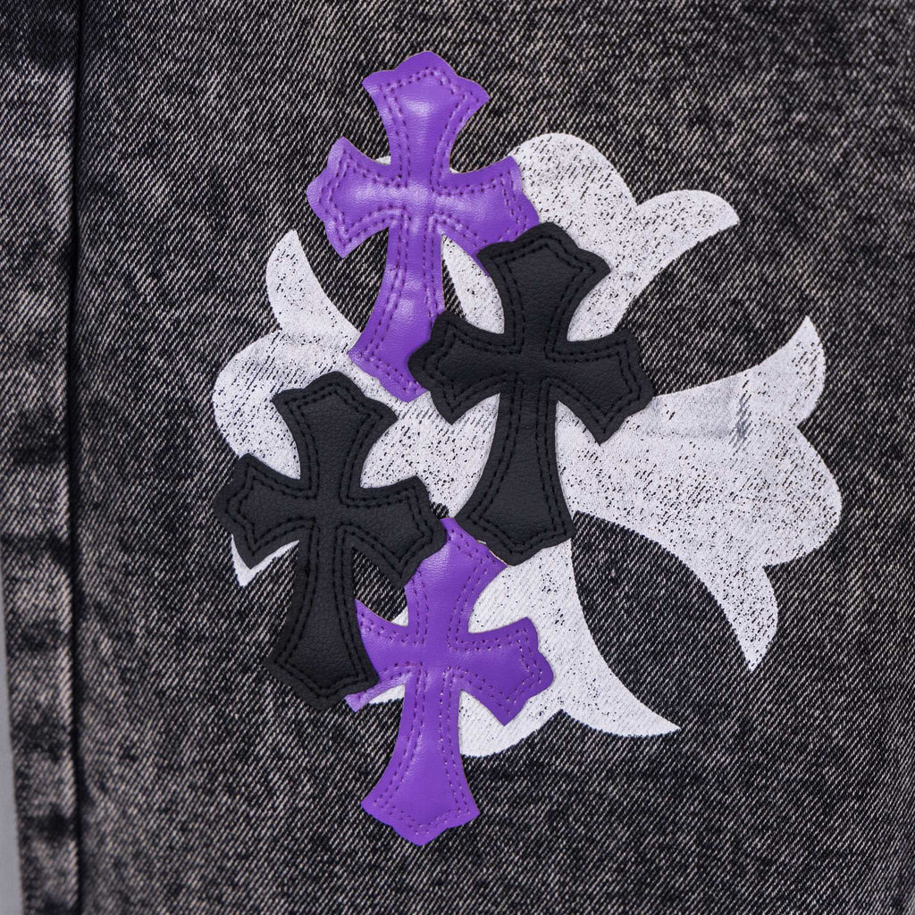 Chrome pants fabric patch close-up with purple, black, and white cross designs