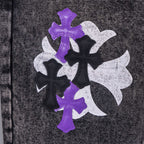 Chrome pants fabric patch close-up with purple, black, and white cross designs