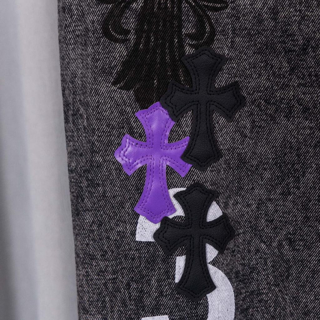 Chrome pants in dark denim with purple and black cross patches on leg