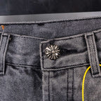 Gray denim pants close-up of waistband button and stitched pocket top