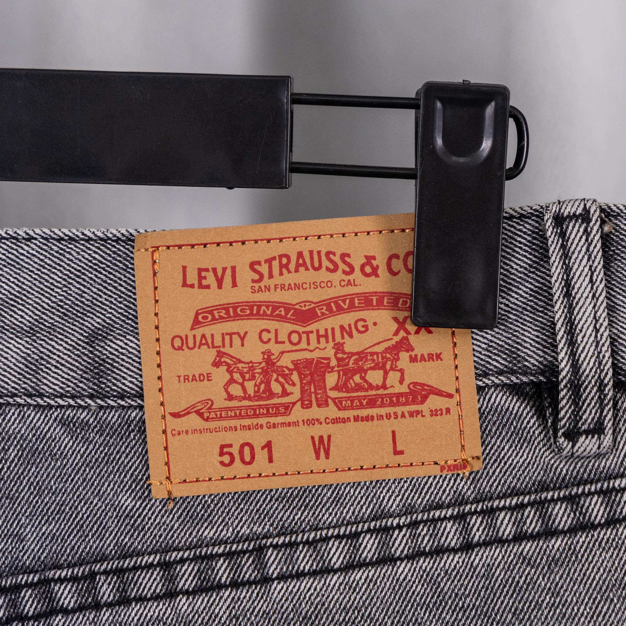 Gray denim pants close-up of waistband Levi Strauss label and inner tag