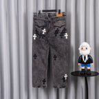 Gray denim pants with dark and white cross patches, belt loops at waistband.